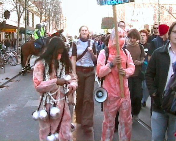 Students in 'blood'-spattered overalls with ball-and-chains