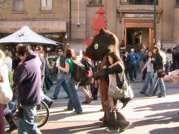 Protester in bear suit being hugged by  ?tourist