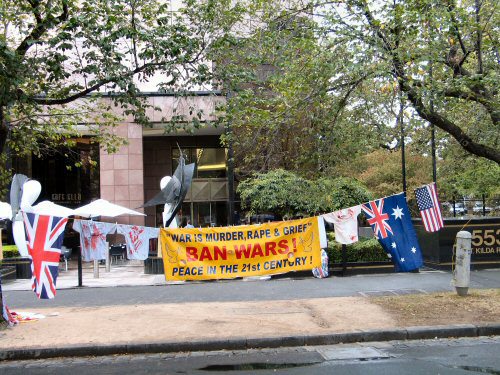 Bammer and flags with bloodied shirts on line strung between trees on footpath