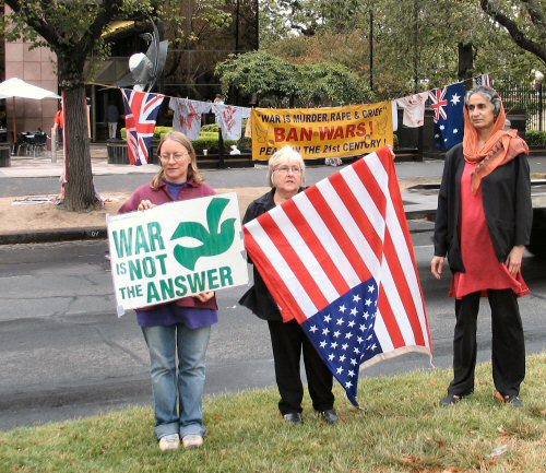 women with us flag and placard - War is not the Answer