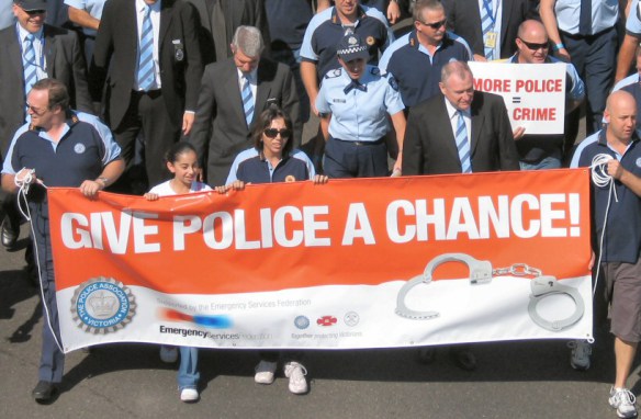 Closeup of head of march - banner reads Give Police a Chance