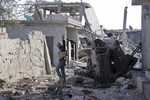 In this Nov. 19, 2014, file photo, a Free Syrian Army fighter from Shams al-Shamal heads to the front line in Kobani, Syria.