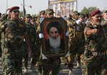 Members of the Abbas combat squad, a Shiite militia group, carry a picture of spiritual leader Grand Ayatollah Ali al-Sistani during a parade in Basra, 340 miles (550 kilometers) southeast of Baghdad, Iraq, Saturday, Sept. 26, 2015.