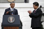 Chinese President Xi Jinping applauds President Barack Obama after his welcoming remarks during an official state arrival ceremony for the Chinese president, Friday, Sept. 25, 2015, on the South Lawn of the White House in Washington.