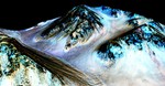 These dark, narrow, 100 meter-long streaks called recurring slope lineae flowing downhill on Mars are inferred to have been formed by contemporary flowing water.