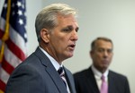 Outgoing House Speaker John Boehner of Ohio listens at right as House Majority Leader Kevin McCarthy of Calif. speaks during a new conference on Capitol Hill in Washington, Tuesday, Sept. 29, 2015.