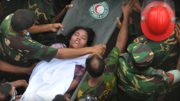 Rescue workers bringing out a survivor from the rubble on April 26th (photo by Stridel/AFP).