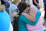 A woman is comforted as friends and family wait for students at the local fairgrounds after a shooting at Umpqua Community College in Roseburg, Ore., on Thursday, Oct. 1, 2015.