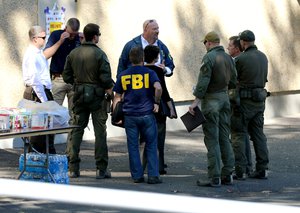 Members of law enforcement have a meeting at the local fairgrounds after a deadly shooting at Umpqua Community College, in Roseburg, Ore., Thursday, Oct. 1, 2015.