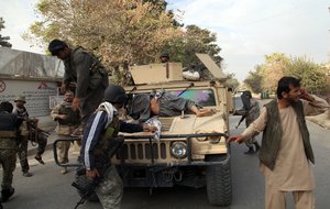 Afghan security forces take a wounded civilian man to the hospital after Taliban fighter's attack, in Kunduz city, north of Kabul, Afghanistan, Saturday, Oct. 3, 2015.