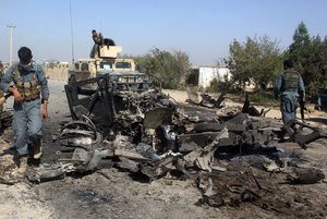 Afghan security forces inspect the site of a U.S. airstrike in Kunduz city, north of Kabul, Afghanistan, Friday, Oct. 2, 2015.