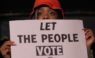 GREENSBORO, NC - NOVEMBER 3:   Keyanna Morrow (cq Keyanna), 19, holds a voter rights sign during a Moral March to the Polls event sponsored by the North Carolina NAACP in Greensboro, NC, on Monday, November 3, 2014.  (Photo by Ted Richardson/For The Washington Post via Getty Images)