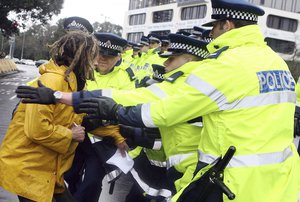 A protestor is arrested during a protest outside the Lagham Hotel where the US Secretary of State Condoleezza Rice was having talks with New Zealand National Party leader John Keys, Auckland, New Zealand, Saturday, July 26, 2008  (AP Photo/NZPA, Wayne Drought)