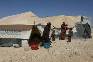 In this Thursday, Oct. 1, 2015 photo, Syrian refugees hang out by their tents at the U.N.-run Zaatari refugee camp near Mafraq, northern Jordan. Growing numbers of Syrian refugees are returning to their war-ravaged homeland from Jordan because they can't survive in exile after drastic aid cuts.