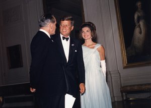 File - President John F. Kennedy and Mrs. Kennedy greet Fredric March during a dinner for Nobel Prize winners of the Western Hemisphere, in the East Room of the White House, 29 April, 1962.