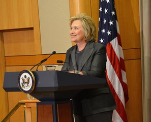 File - Former Secretary of State Hillary Rodham Clinton delivers remarks with Secretary of State John Kerry and former Secretaries of State Henry A. Kissinger, James A. Baker, III, Madeleine K. Albright, and Colin L. Powell at the Groundbreaking Ceremony of the U.S. Diplomacy Center at the U.S. Department of State in Washington, DC on September 3, 2014.