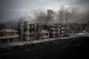 In this Tuesday, Oct. 2, 2012 file photo, smoke rises over Saif Al Dawla district, in Aleppo, Syria.