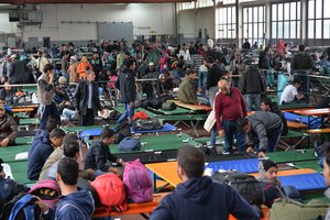 Refugees wait in a crowded migrant registration center in Passau, southern Germany, Thursday, Oct. 8, 2015.