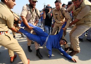 Indian policemen detain a supporter of Engineer Rashid Ahmed, an independent member of the Jammu and Kashmir state assembly during a protest in Srinagar, Indian controlled Kashmir, Friday, Oct. 9, 2015. Police in Indian portion of Kashmir detained dozens of supporters of Ahmed during a protest against India's ruling Bharatiya Janata Party or BJP after their Lawmakers kicked and punched Ahmed for hosting a party where he served beef on Thursday. Hindus consider cows to be sacred, and slaughtering the animals is banned in most Indian states.