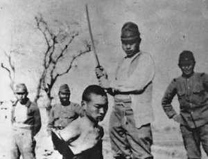 File - A Chinese POW about to be beheaded by a Japanese officer during the Nanking (Nanjing) Massacre, 1937. An estimated 40,000 to over 300,000 Chinese civilians and disarmed combatants were murdered during the massacre, with rape and looting widespread.