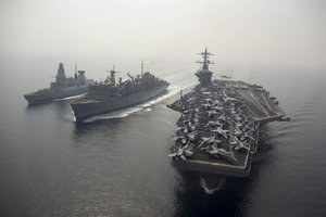 File - The aircraft carrier USS Theodore Roosevelt participates in a replenishment-at-sea with the  Military Sealift Command fast combat support ship USNS Arctic and the British Royal Navy destroyer HMS Duncan, Arabian Gulf, 26 August, 2015. Theodore Roosevelt is supporting Operation Inherent Resolve, involving strike operations in Iraq and Syria as directed.