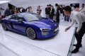 Visitors look at the Audi R8 e-tron, a driverless electronic car, as it is displayed at the inaugural International Consumer Electronics Show (CES) Asia in Shanghai, Tuesday, May 26, 2015. The well-known electronics trade show is being held in Asia for the first time. (Chinatopix Via AP) CHINA OUT