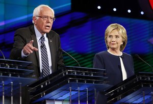 Hillary Rodham Clinton, right, looks on as Sen. Bernie Sanders, of Vermont, speaks during the CNN Democratic presidential debate Tuesday, Oct. 13, 2015, in Las Vegas. (AP Photo/John Locher)