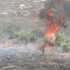 Palestinian civil workers attempt to put out fires while fire truck prohibited entry