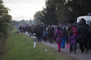 People walks towards Hungary after disembarking from a train in Botovo, on the Croatia-Hungary border, Friday, Oct. 16, 2015. Hungary clamped down on its border with Serbia with a barrier on Sept. 15 and says it will close down its border with Croatia to migrants starting at midnight.