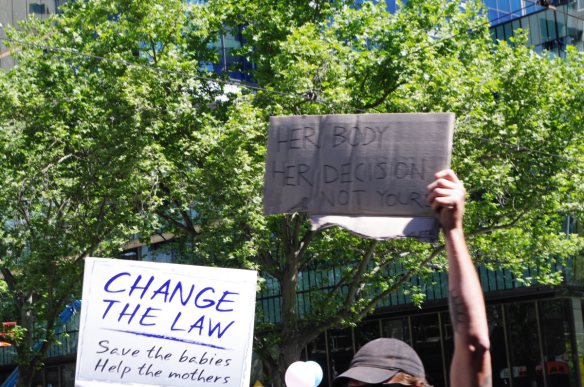 Opposing placards on the march