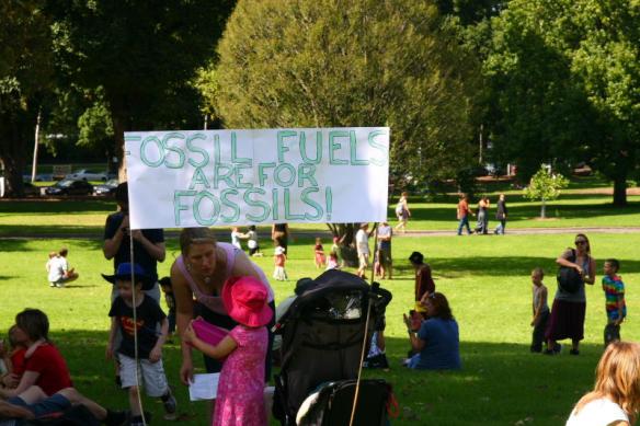 Children in park with banner - 'Fossil Fuels are for Fossils'