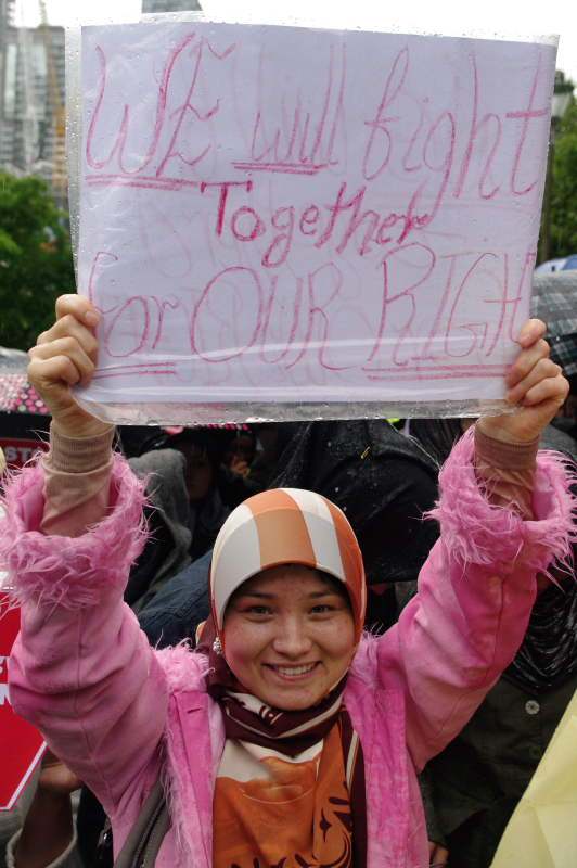 Young woman with placard - We will fight together for our Rights