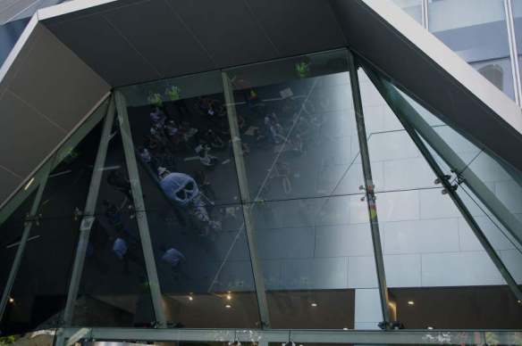 Reflection of protest in glass ceiling of foyer