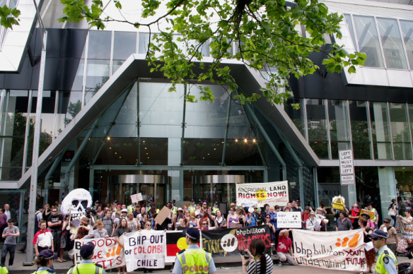 Protesters lined up with banners and placards in front of BHP head office