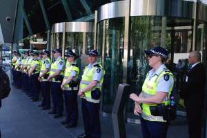 Long line of uniformed police across BHP office frontage