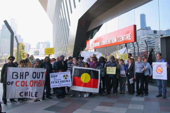 Protesters line up with banners and placards at entrance