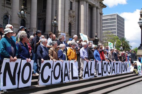 Placards spelling "No Coal Allocation"