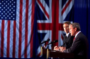 File - President George W. Bush appears with British Prime Minister Tony Blair at a press conference at Crawford High School in Crawford, Texas on April 6, 2002.