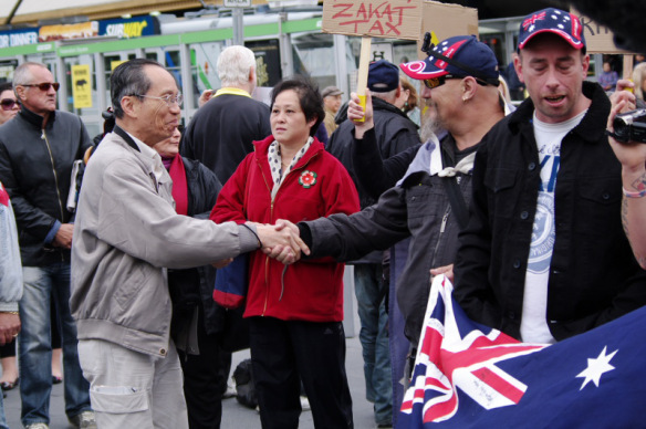 Elderly Asian gentleman shakes ADL supporter's hand ...