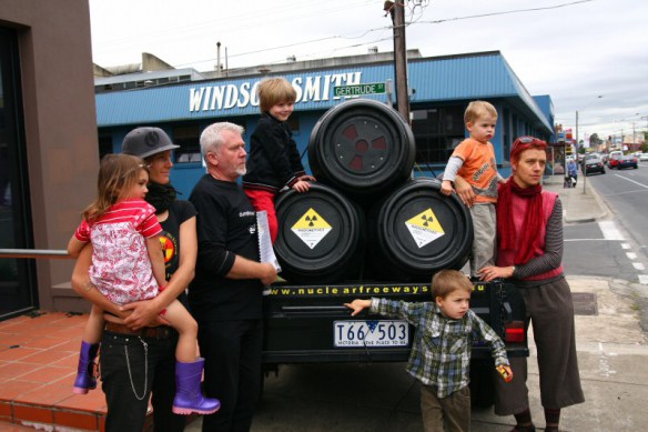 Dave Sweeney holds petition with other campaigners alongside trailer