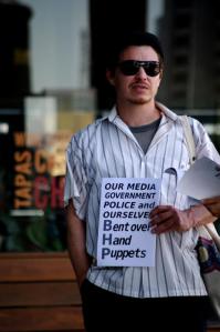 Member of JFP with anti-BHP placard