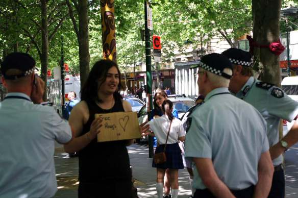 Protester offering free hugs to police