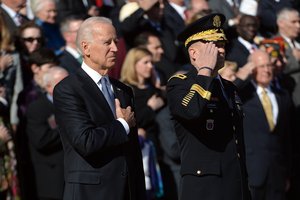 Vice President Joe Biden, left, and Maj. Gen. Jeffrey S. Buchanan, commander of U.S. Army Military District of Washington, render honors during the playing of taps at the Tomb of the Unknown Soldier during the Veterans Day ceremony at Arlington, Va., Nov. 11, 2014. DOD News photo by EJ Hersom