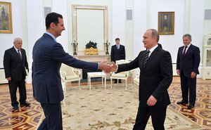 Syrian President Bashar al-Assad greets Russian President Vladimir Putin at the Kremlin, Moscow, Russia, 20 October, 2015.