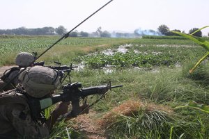 Marines suppress enemy positions to protect the landing zone for a casualty evacuation helicopter in the middle of a six-hour firefight with Taliban insurgents.