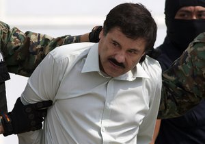 Joaquin "El Chapo" Guzman is escorted to a helicopter in handcuffs by Mexican navy marines at a navy hanger in Mexico City, Saturday, Feb. 22, 2014.