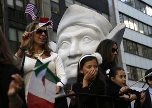 Participants in the Columbus Day Parade ride a float with a large bust of Christopher Columbus in New York, Monday, Oct. 12, 2015.