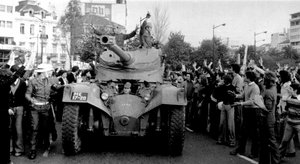 In this April 25 1974 file picture, people cheer soldiers in a tank driving through downtown Lisbon during a military coup.