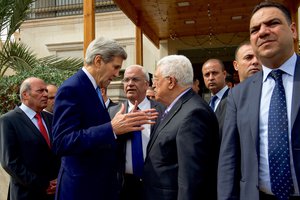 U.S. Secretary of State John Kerry speaks with Palestinian Authority President Mahmoud Abbas and Chief Palestinian Negotiator Saeb Erekat after a bilateral meeting on October 24, 2015, in Amman, Jordan.