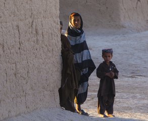 File - Afghan children watch a convoy of Marines pass their home during a combat logistics patrol conducted by Combat Logistics Regiment 2, Regional Command (Southwest), in Helmand province, Afghanistan, Sept. 22, 2013. T